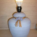 Vintage ceramic lamp foot with ball necklace and raffia.