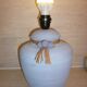 Vintage ceramic lamp foot with ball necklace and raffia.