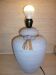 Vintage ceramic lamp foot with ball necklace and raffia.