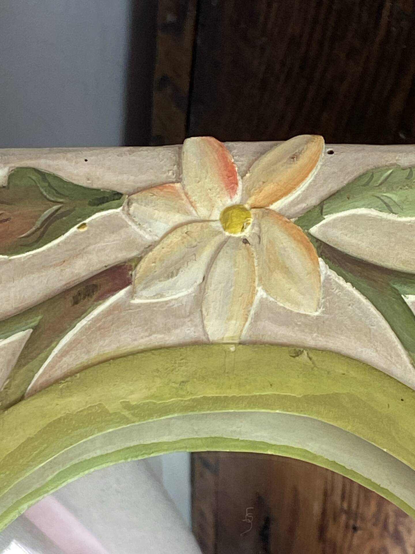 Carved wooden mirror, colourful floral decoration.