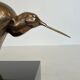 Bronze sculpture representing a stylised bird on a black marble base, signed and numbered.