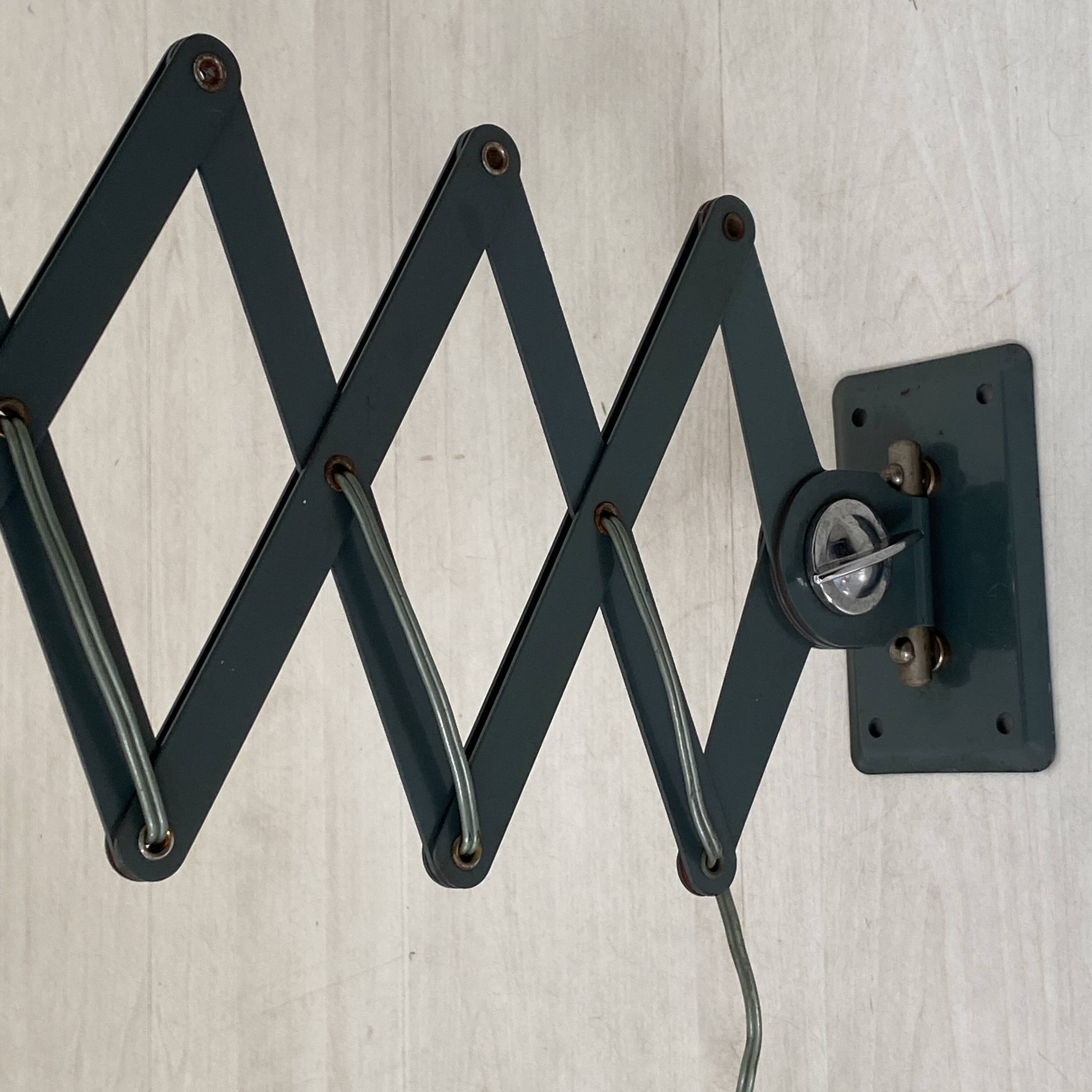 Vintage 1950s green lacquered sheet metal workshop wall light with accordion arm.
