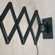 Vintage 1950s green lacquered sheet metal workshop wall light with accordion arm.