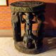 African wooden stool carved in the shapes of characters