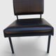 Modernist armchair in black faux leather and metal – 1960s