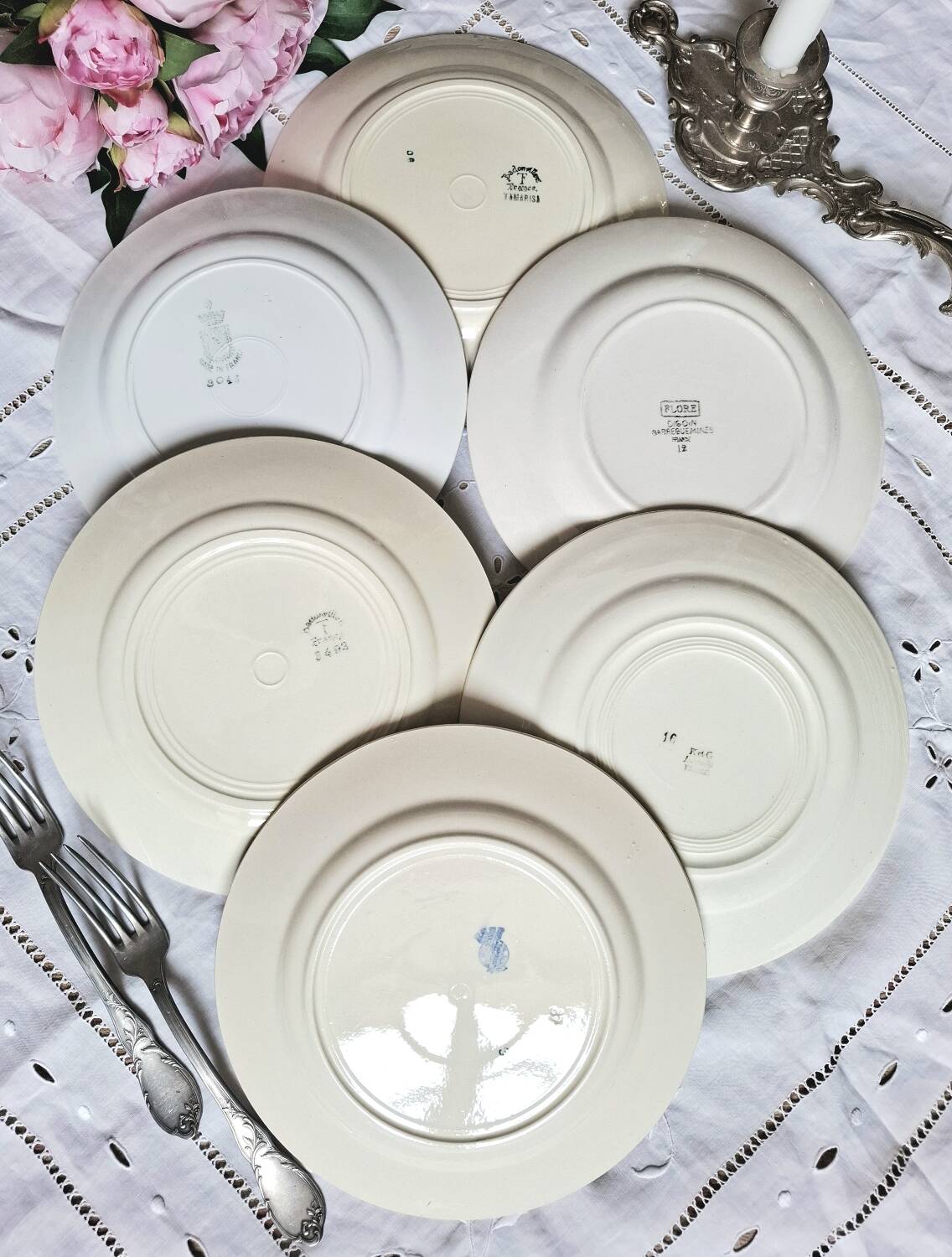 Mismatched antique flat plates accompanied by dishes.