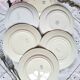 Mismatched antique flat plates accompanied by dishes.