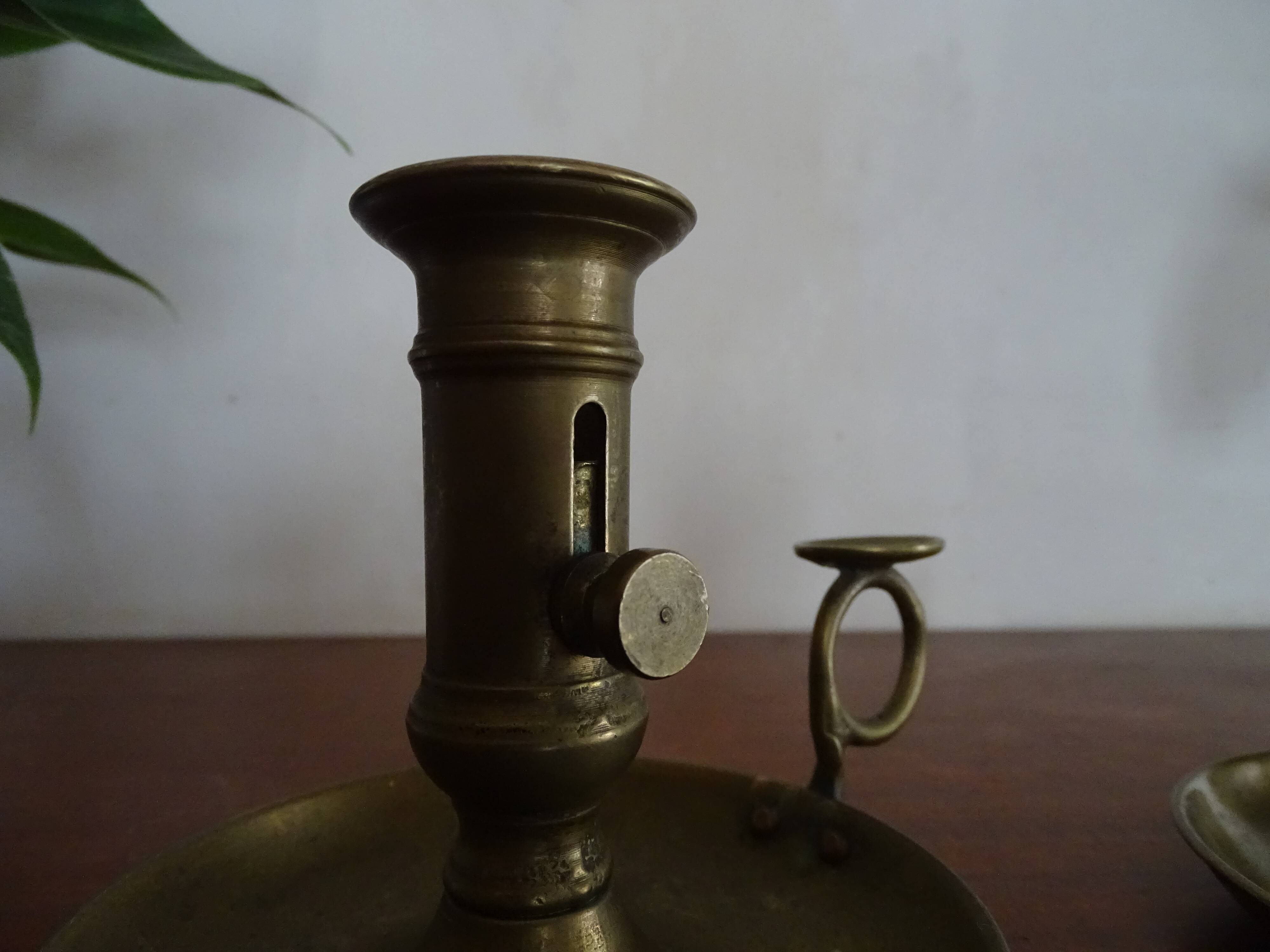 Pair of vintage brass pusher candle holders