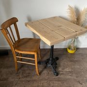 Bistro table with a central cast iron base in industrial style.