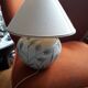 Antique ceramic lamp with a floral design.