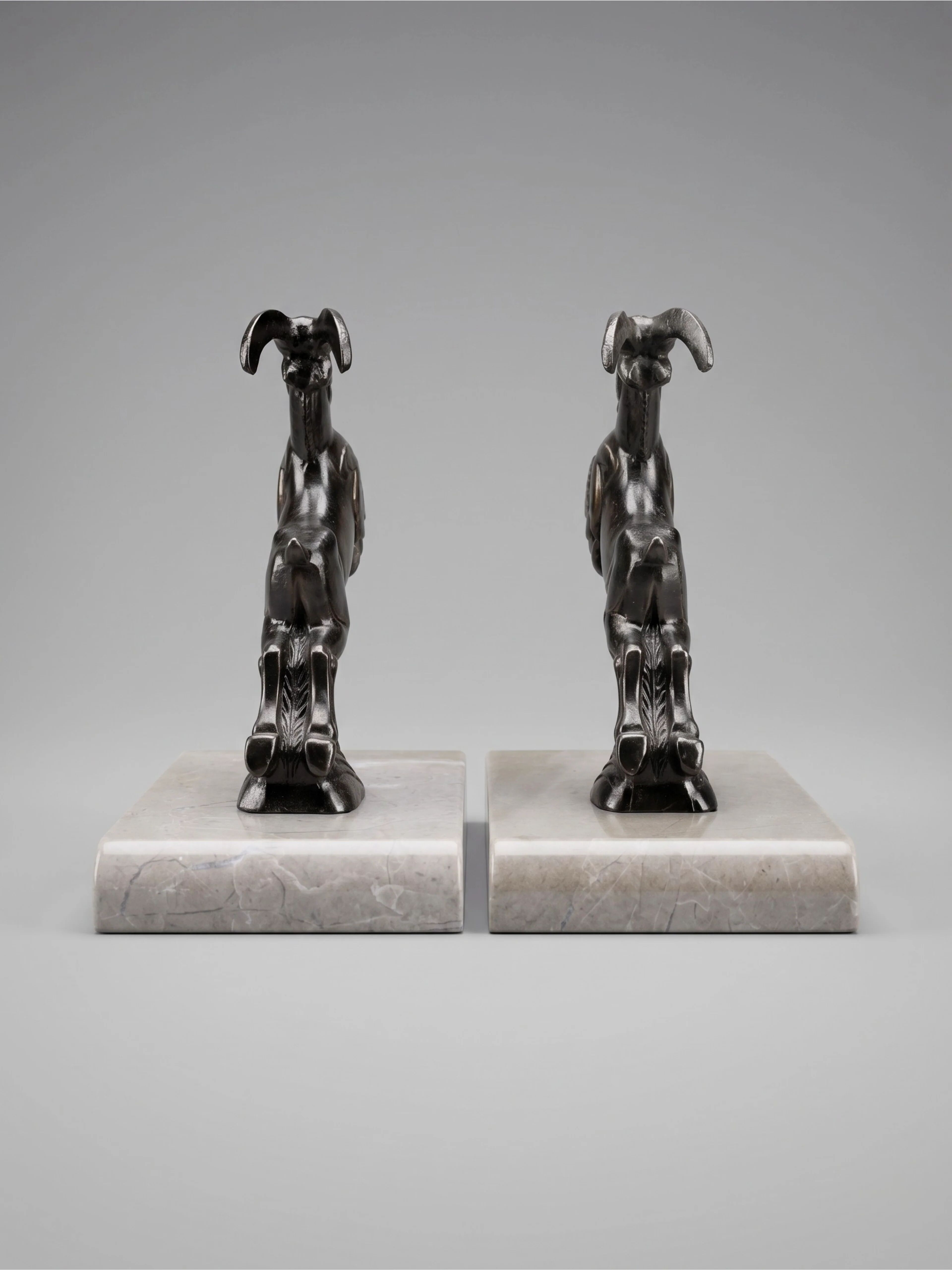 Art Deco bookends with patinated ibex in a taupe marble base.