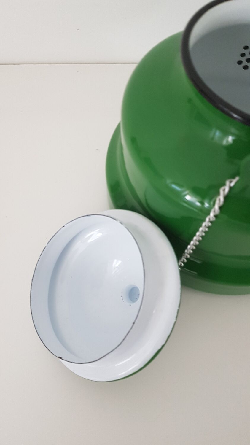 Old green kettle in enamelled metal