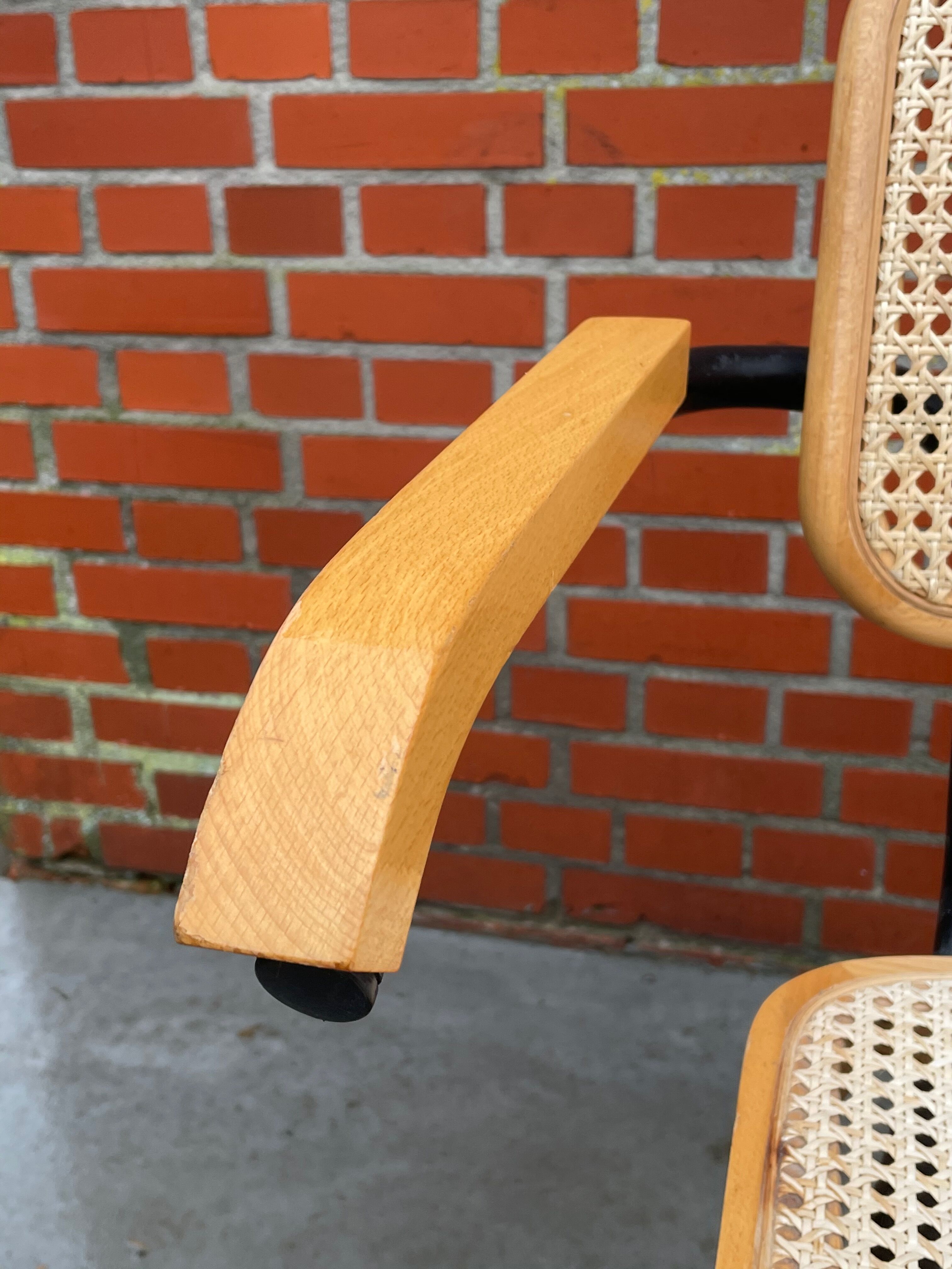 Cesca model chair designed by Marcel Breuer with black-framed armrests