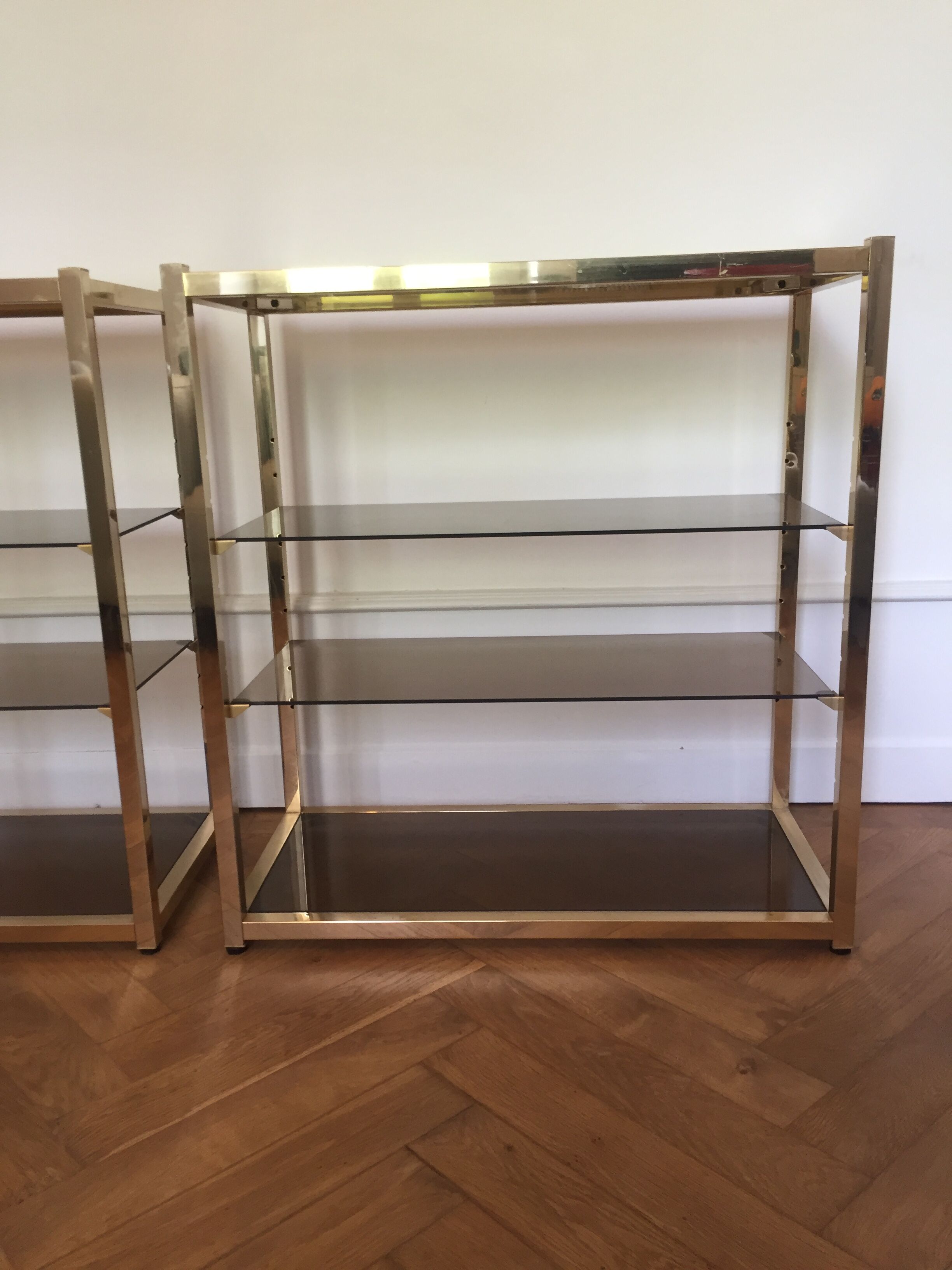 Pair of consoles brass shelves and smoked glass design Roche Bobois