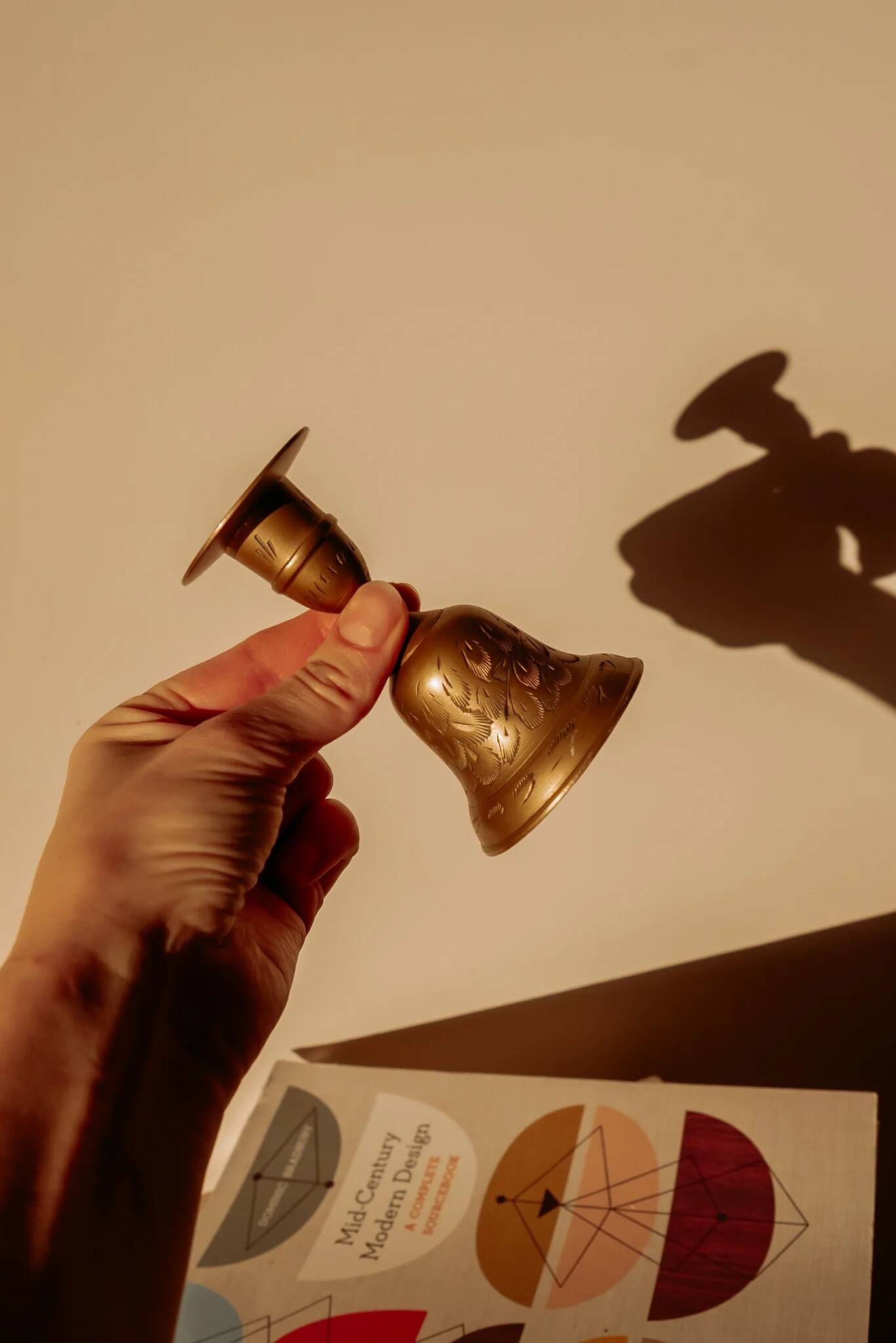 Brass candlestick in the shape of a bell.