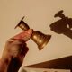 Brass candlestick in the shape of a bell.