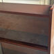 Vintage 1960s wooden library with sliding doors.