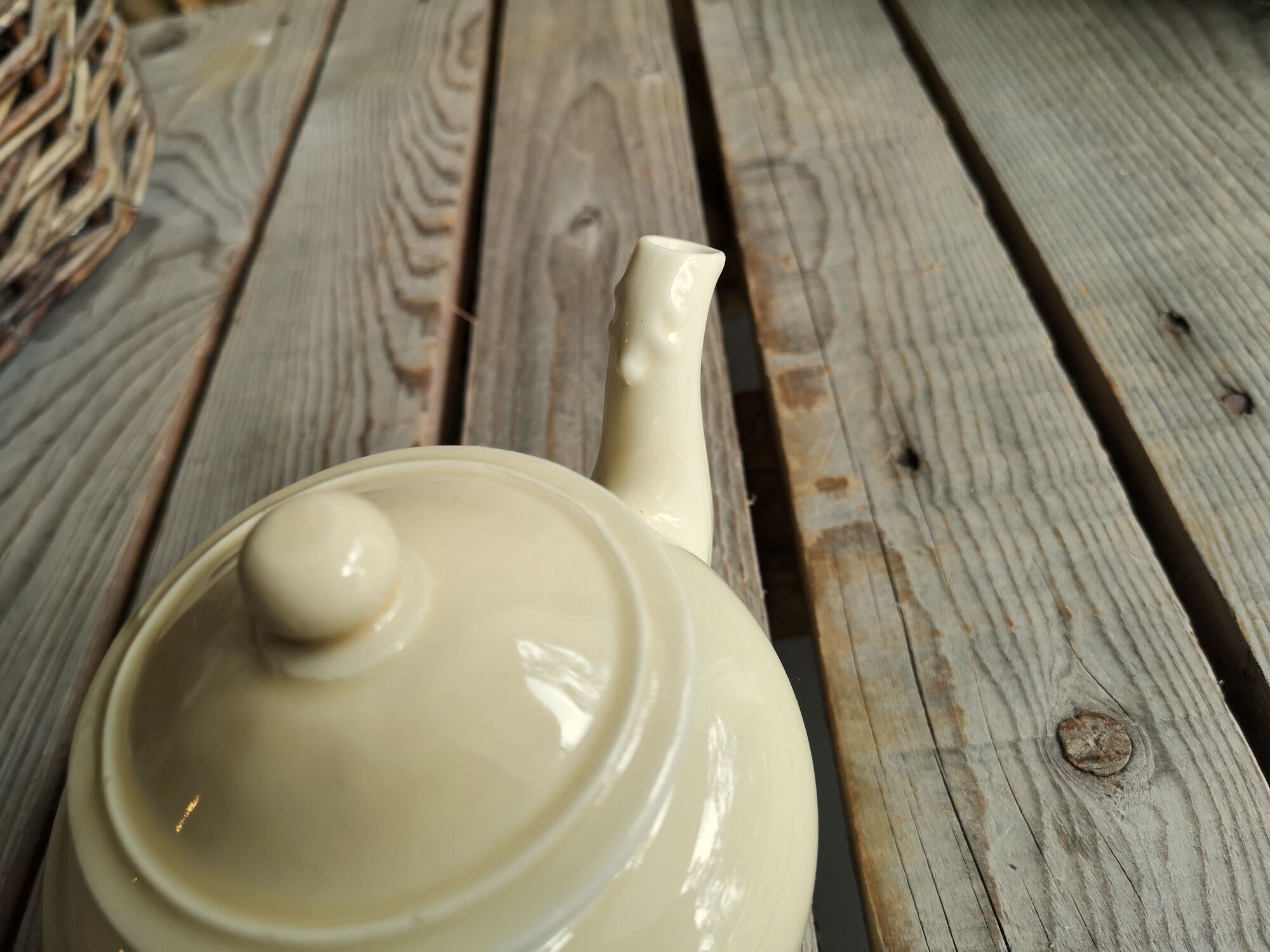 Little ancient teapot in ceramics color cream