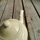 Little ancient teapot in ceramics color cream