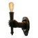 Wall lamp in iron shaped like an arm.
