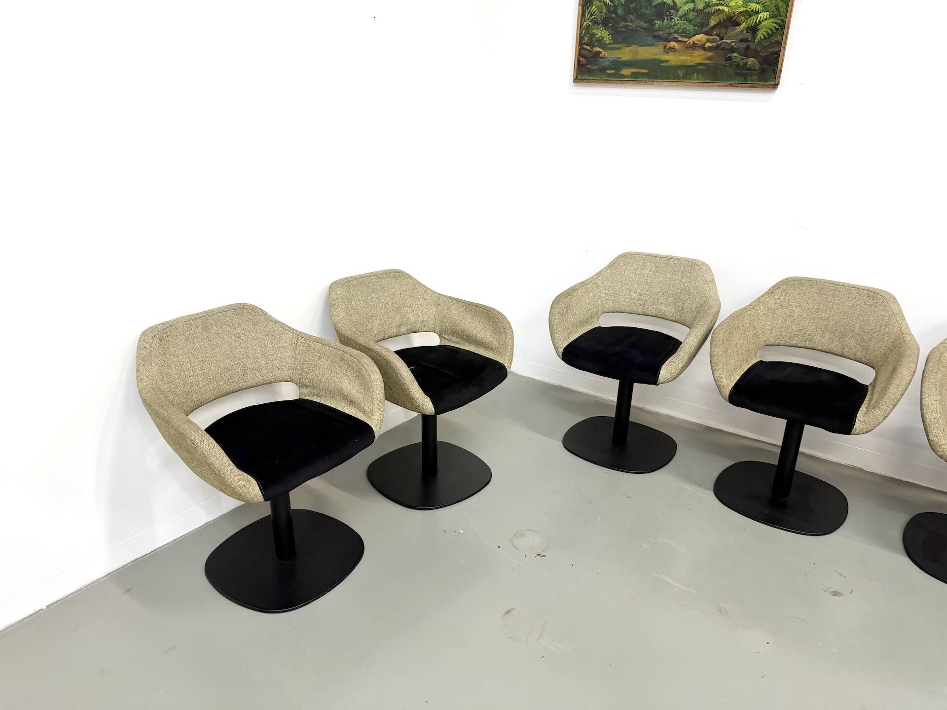 Series of six swivel chairs with an organic shell, patterned fabric and base.