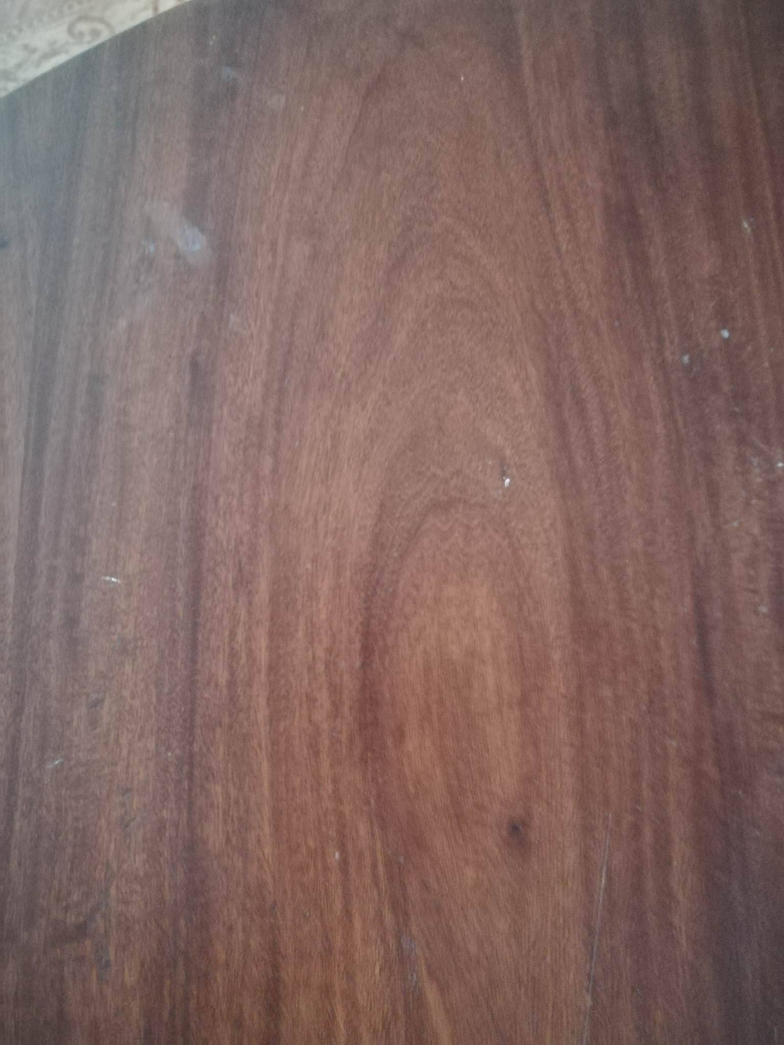 Round wooden table with thin legs