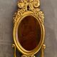 Oval view mirror in gilded wood with leafy decoration in Regency style
