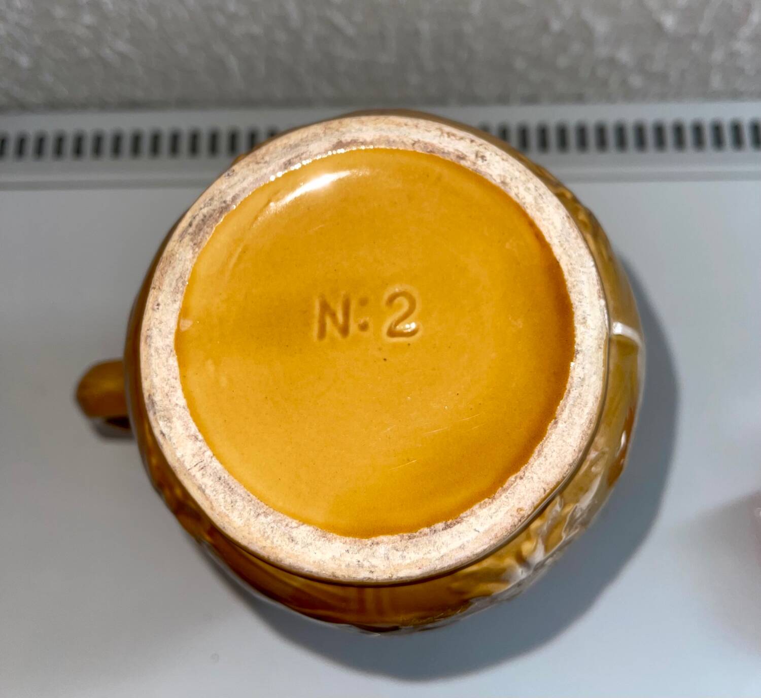 Antique pitcher with flower decoration