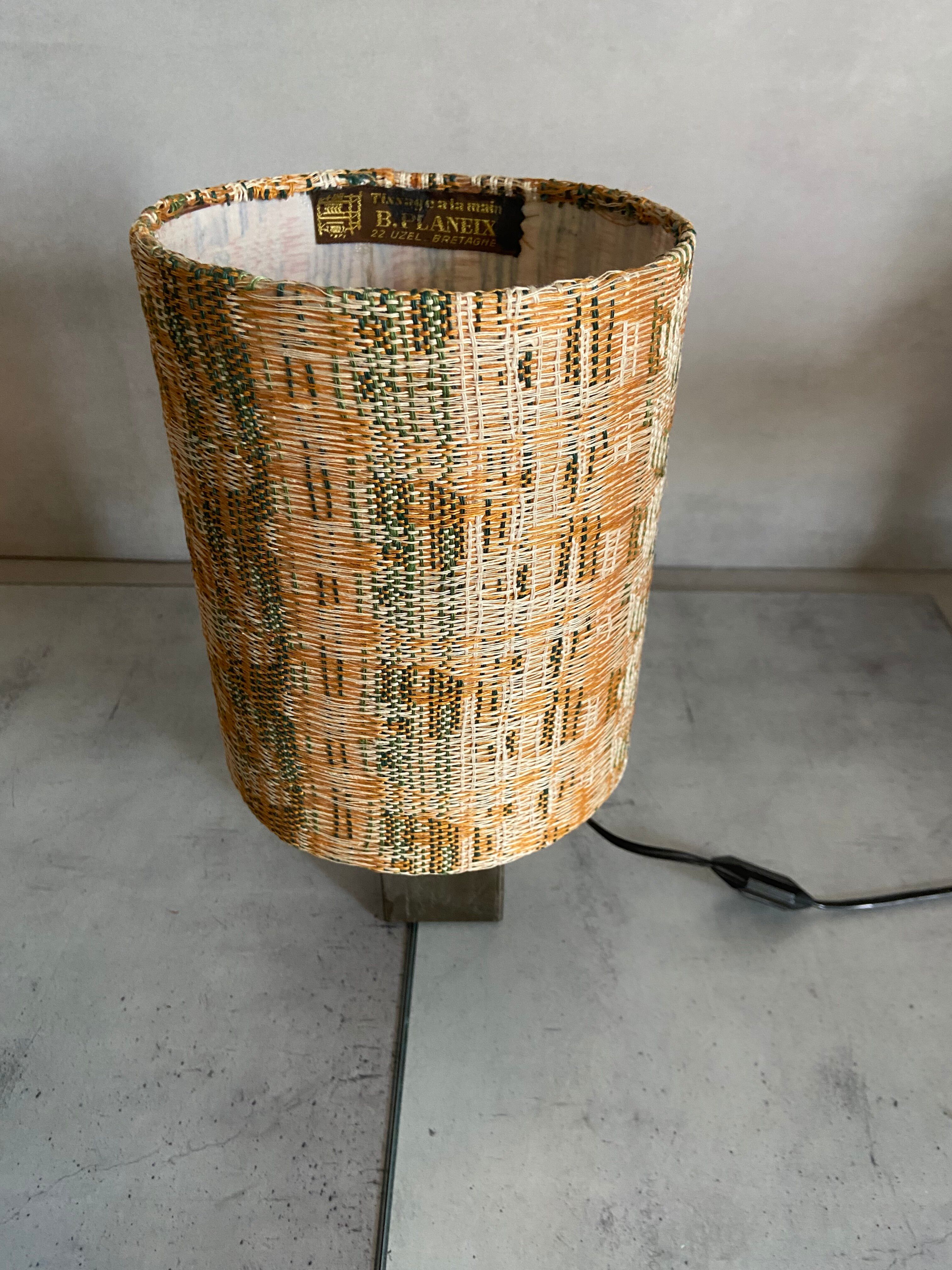 Small modernist table lamp with hand-woven shade.