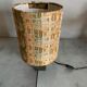 Small modernist table lamp with hand-woven shade.