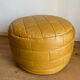2 poufs moutarde patchwork en cuir de Sède