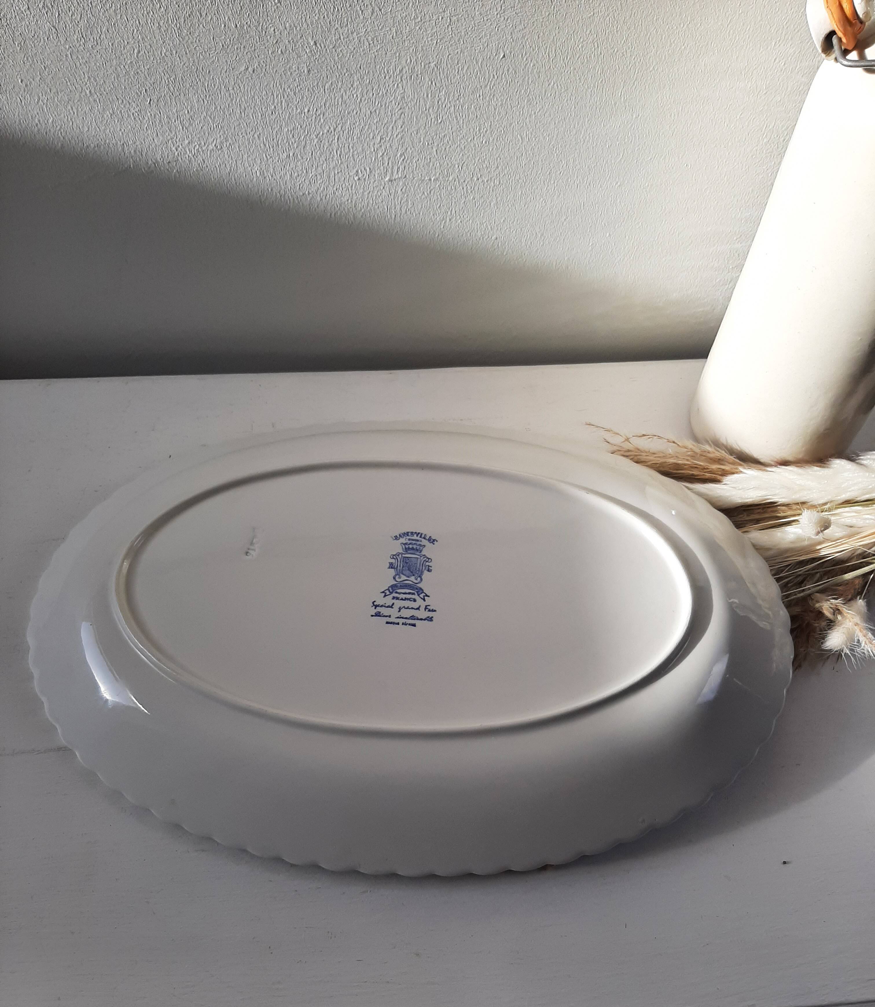 Keller and Guérin Lunéville serving dish with blue flowers on a white background.