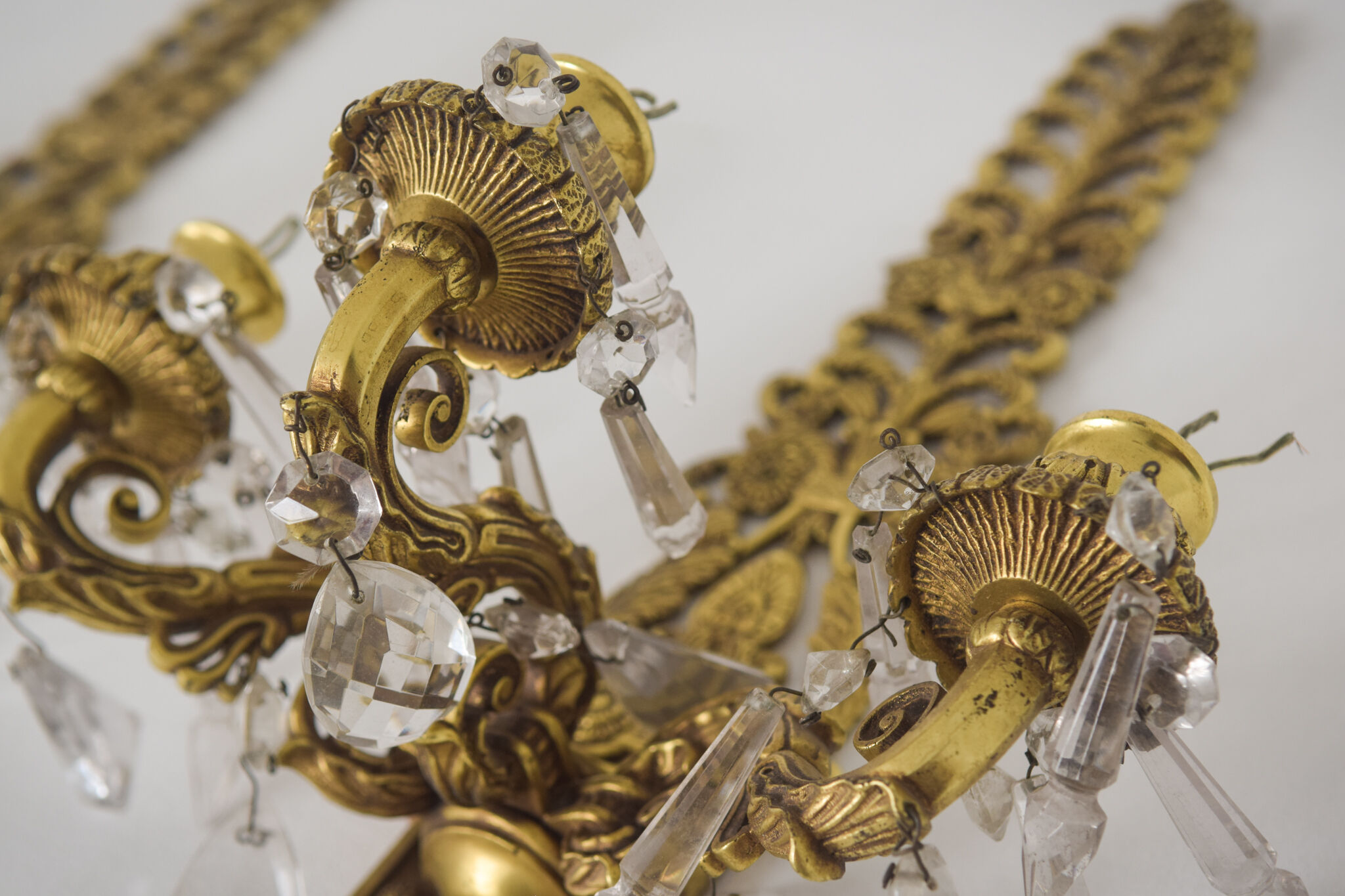 Two bronze and cut glass wall-mounted chandeliers