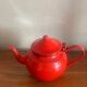 Red enamelled sheet metal teapot