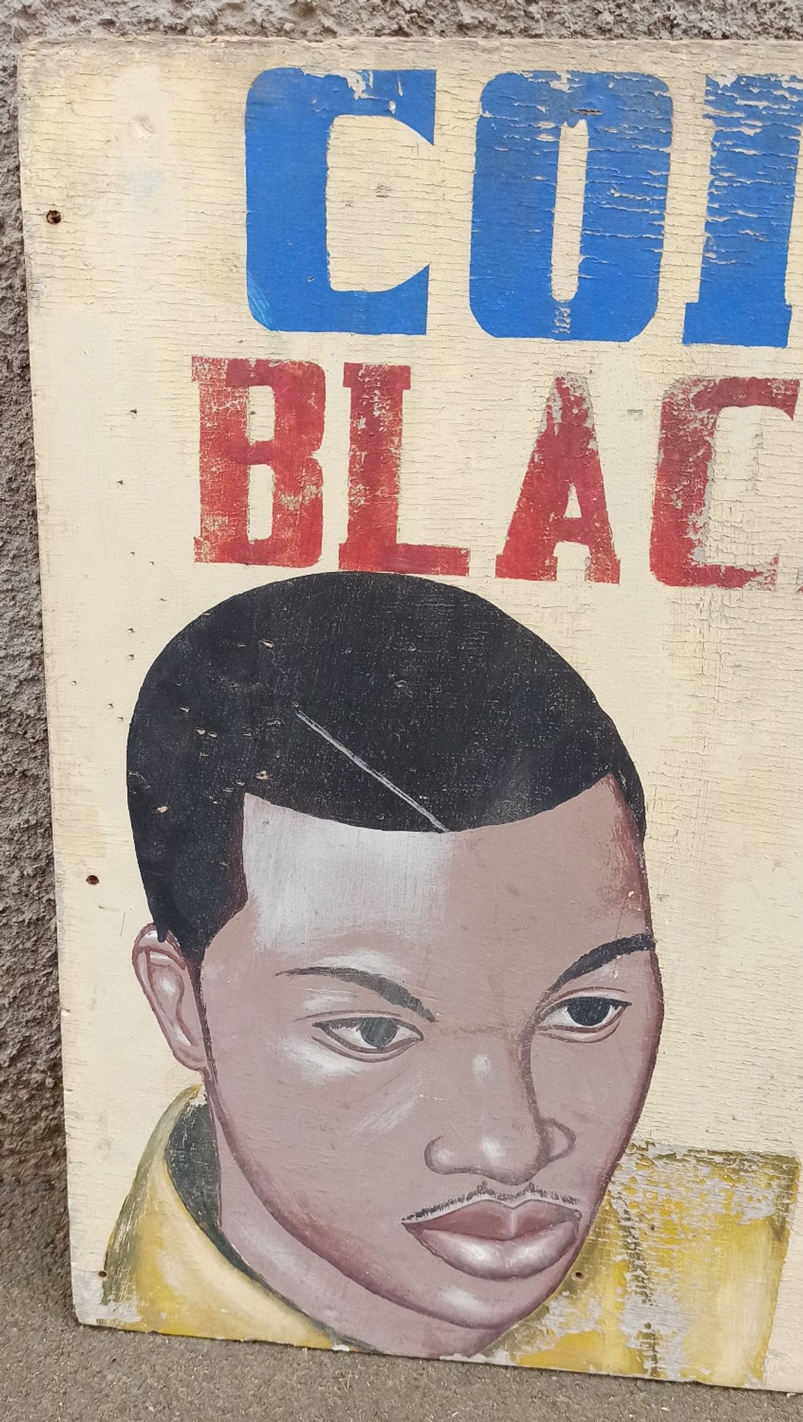 Ancienne enseigne de coiffeur africain