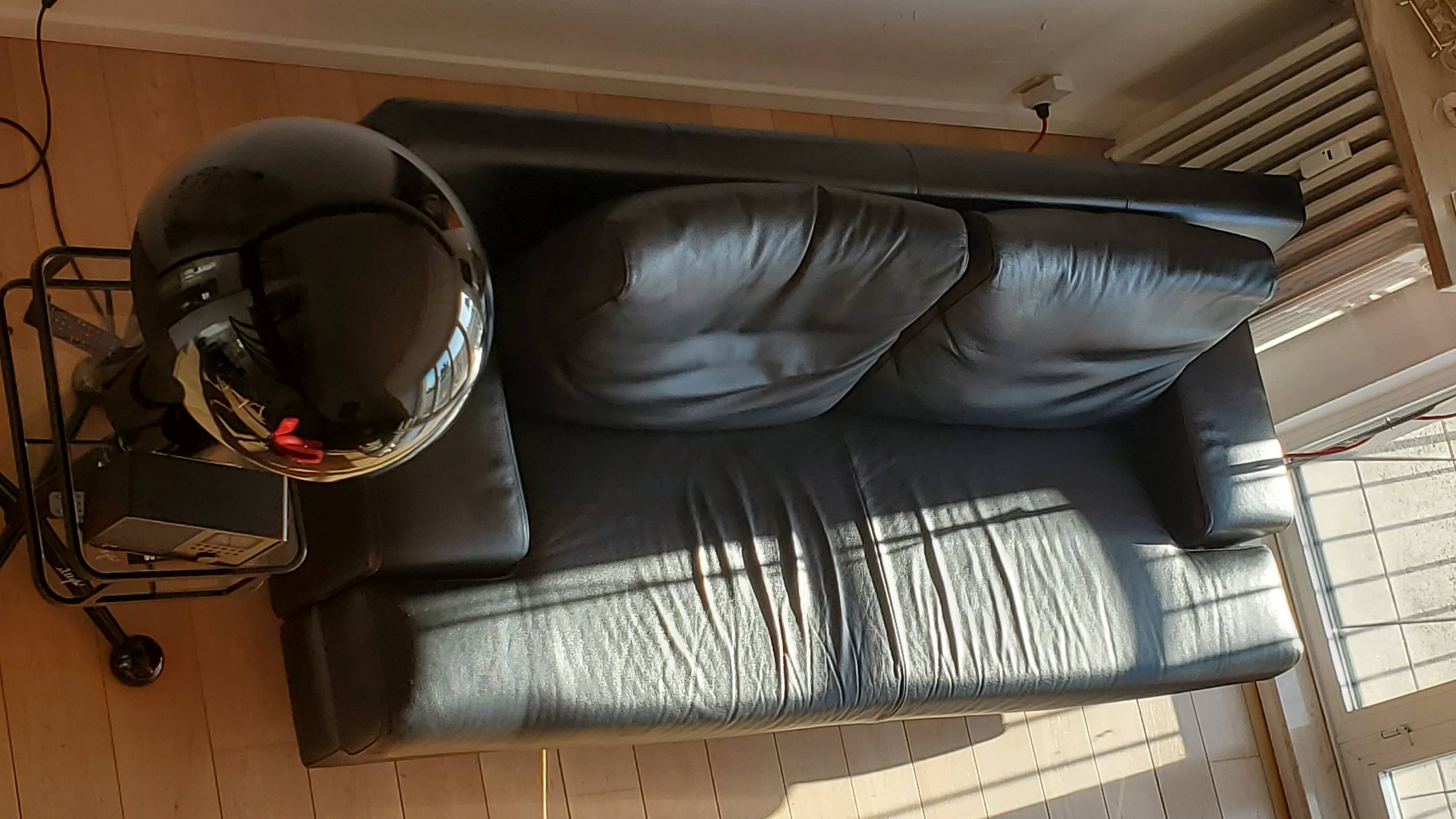 Black leather three-seater sofa