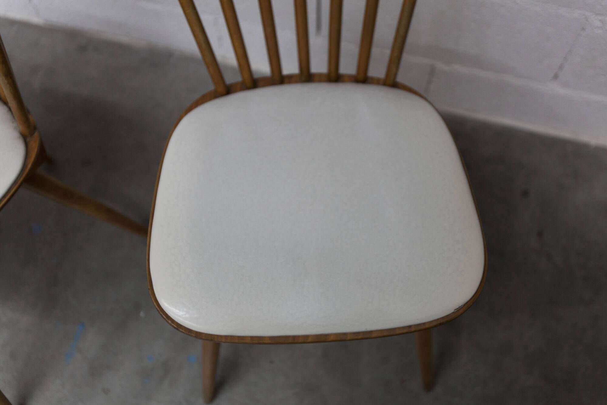 Pair of Baumann Menuet chairs, Honey patina, White skai seat