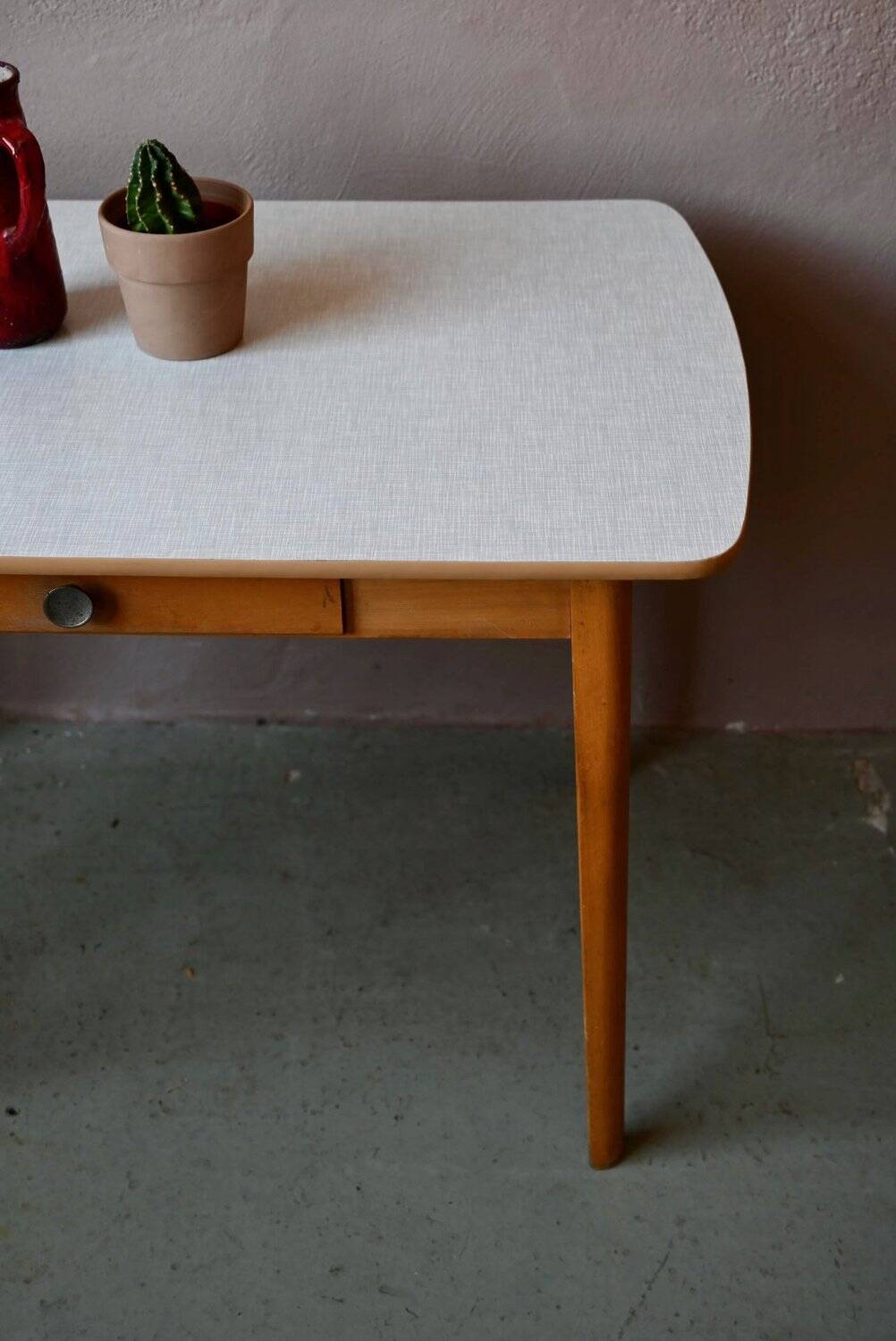 1950s Formica kitchen table with tapered legs and vintage drawer.