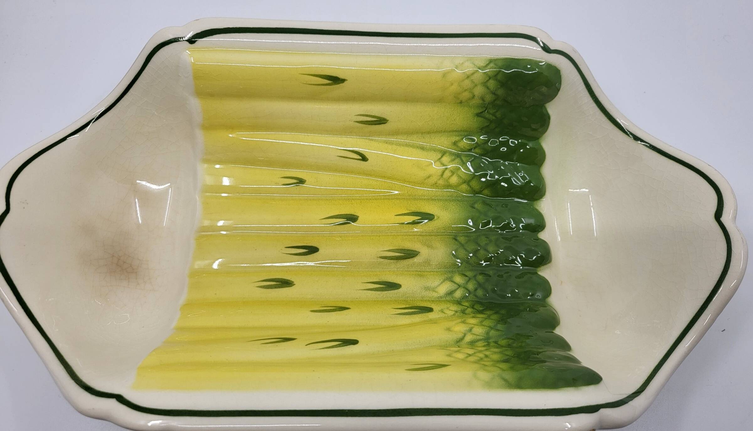 Salins earthenware slip dish decorated with asparagus, French, yellow and green, 20th century