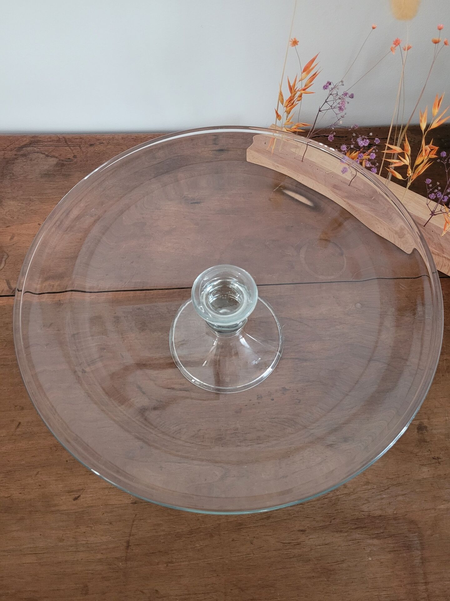 Large glass display plate mounted on a stand.