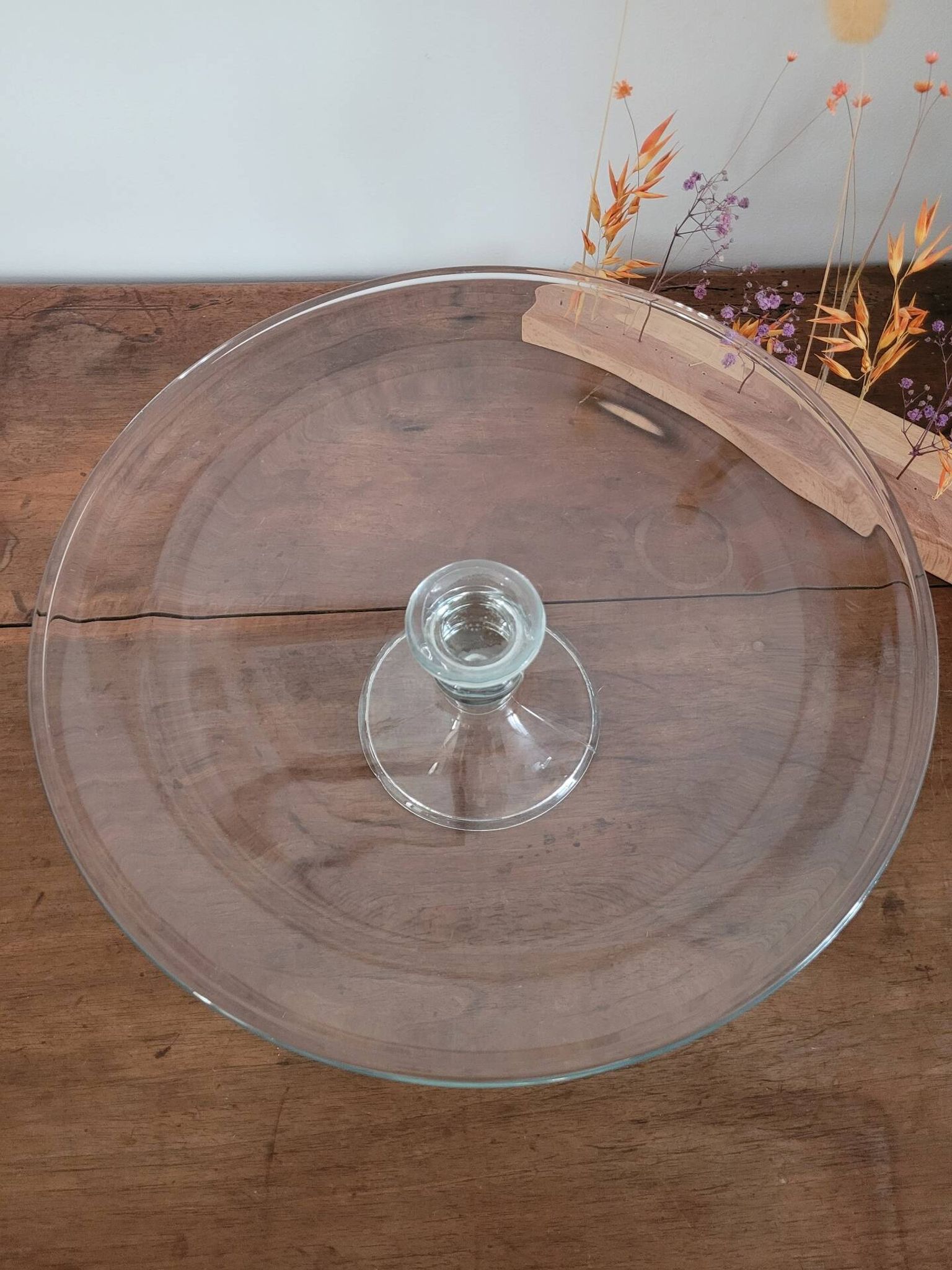 Large glass display plate mounted on a stand.