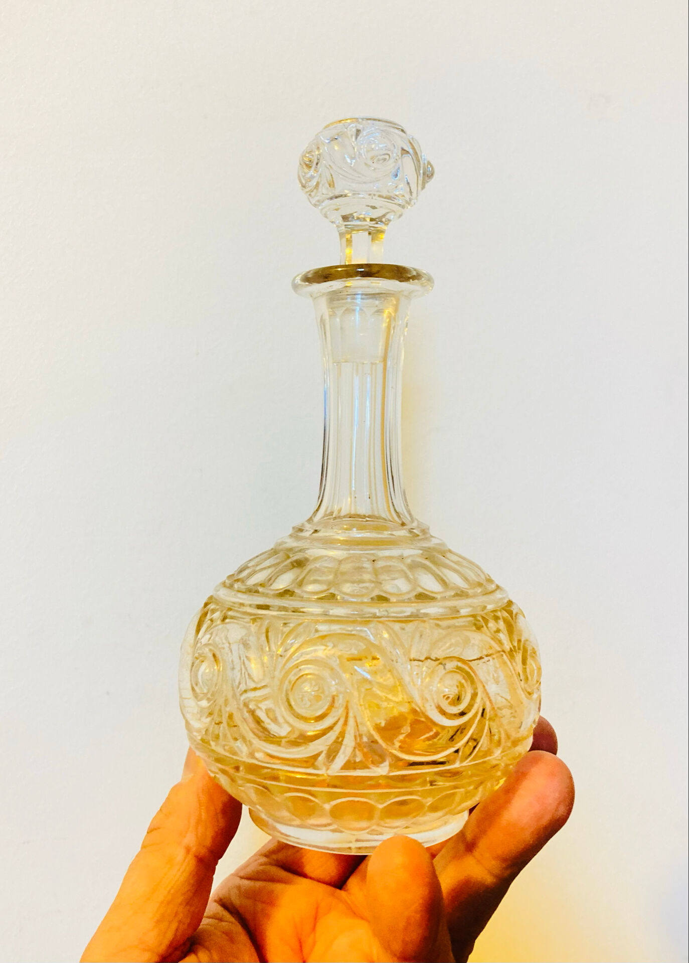 19th-century liqueur carafe in glass adorned with relief patterns.