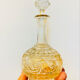 19th-century liqueur carafe in glass adorned with relief patterns.