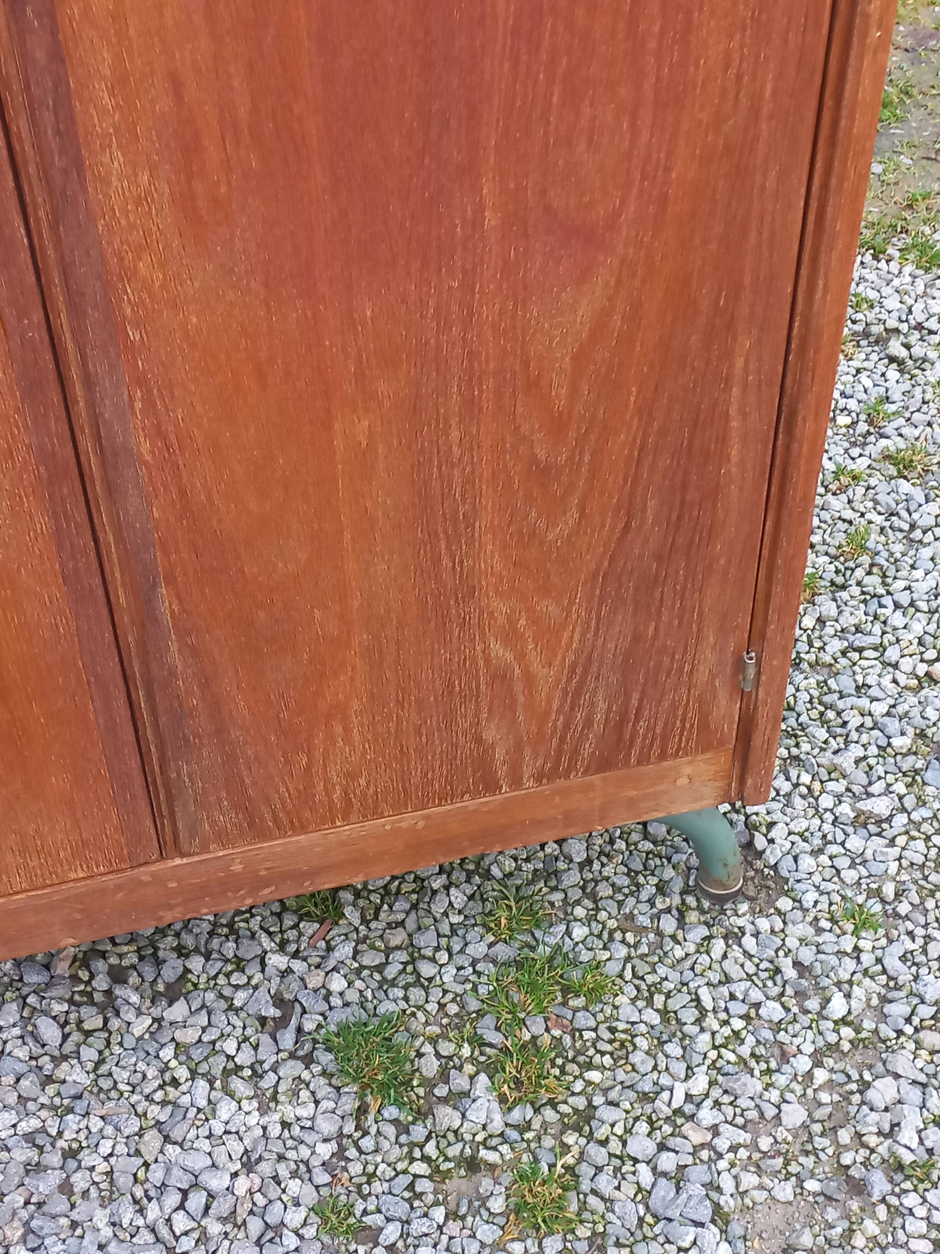 Vintage oak wardrobe with metal legs from the 1950s.