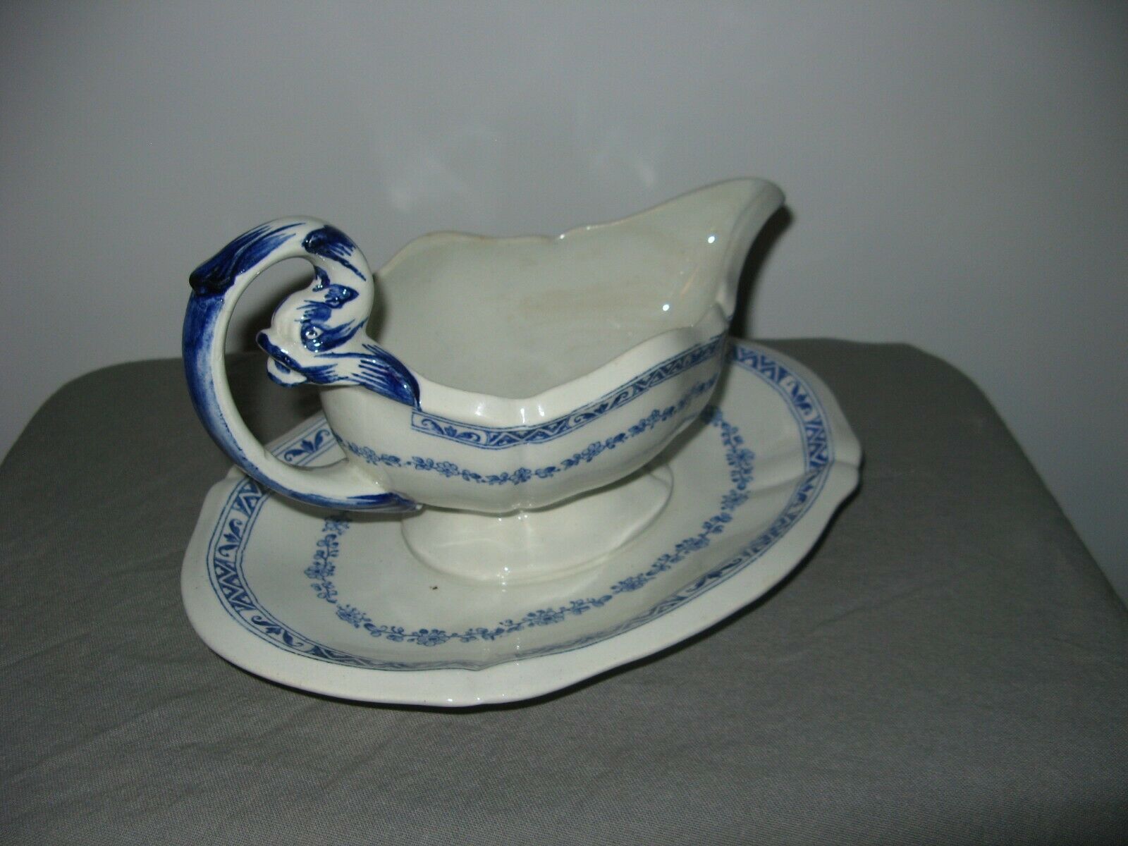 Saucière in Gien earthenware anse in the shape of a dolphin decoration garland 1900