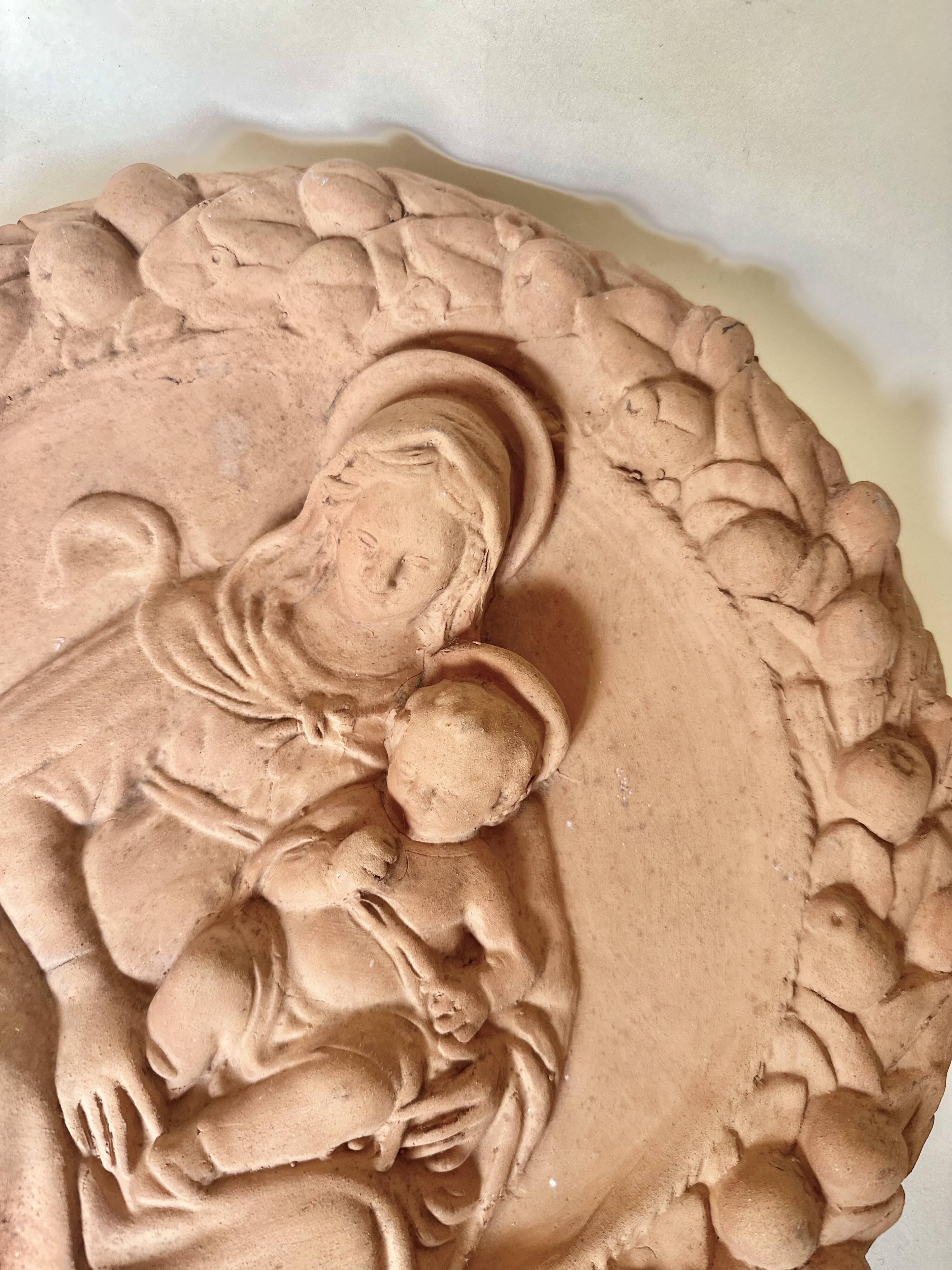 Wall medallion of the Virgin and Child in terracotta