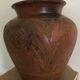 Vase or pot in brown terracotta with artistic decoration of fish.