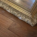 Antique mirror with a wooden and gilded stucco frame.