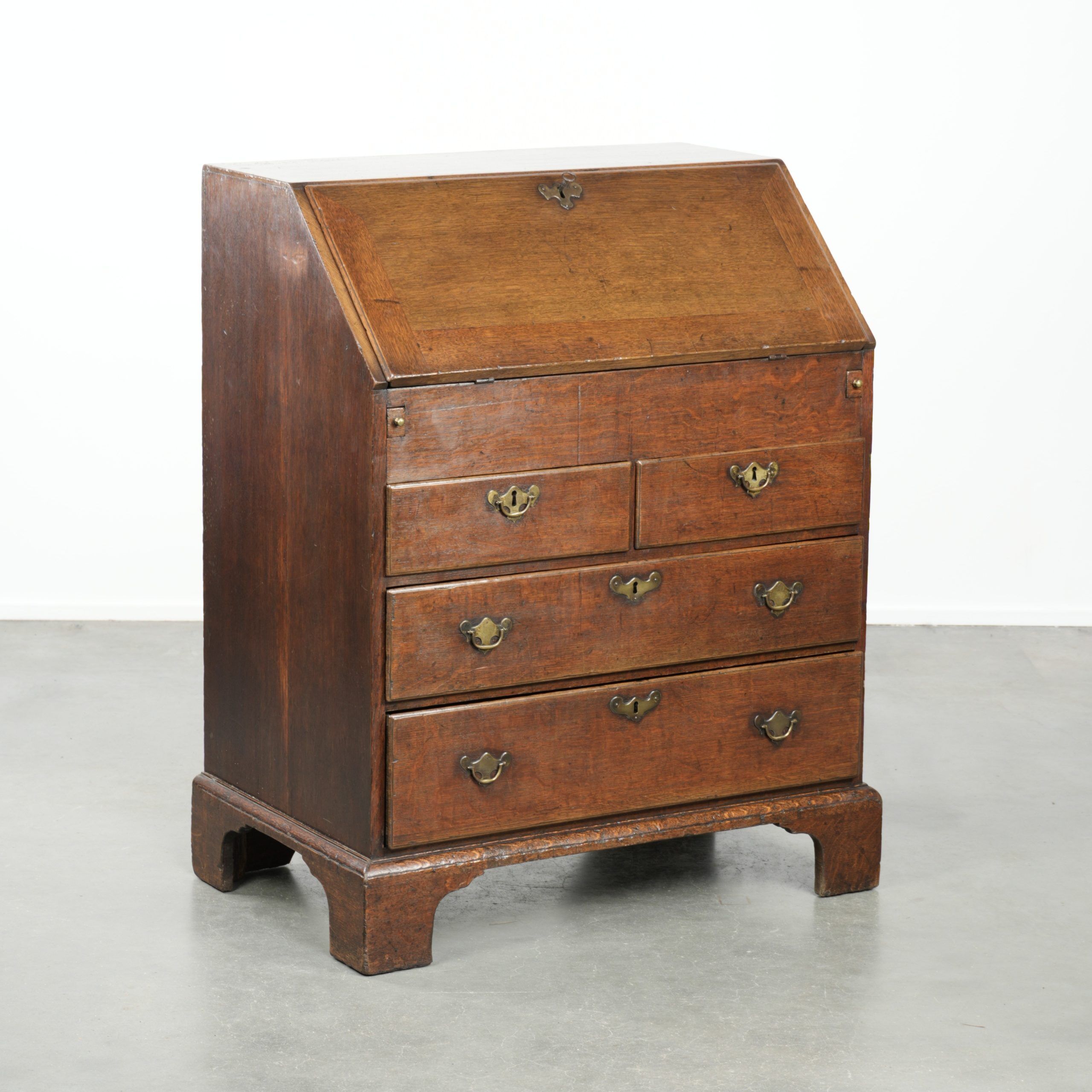Antique English oak secretary from the 18th century with a stepped interior