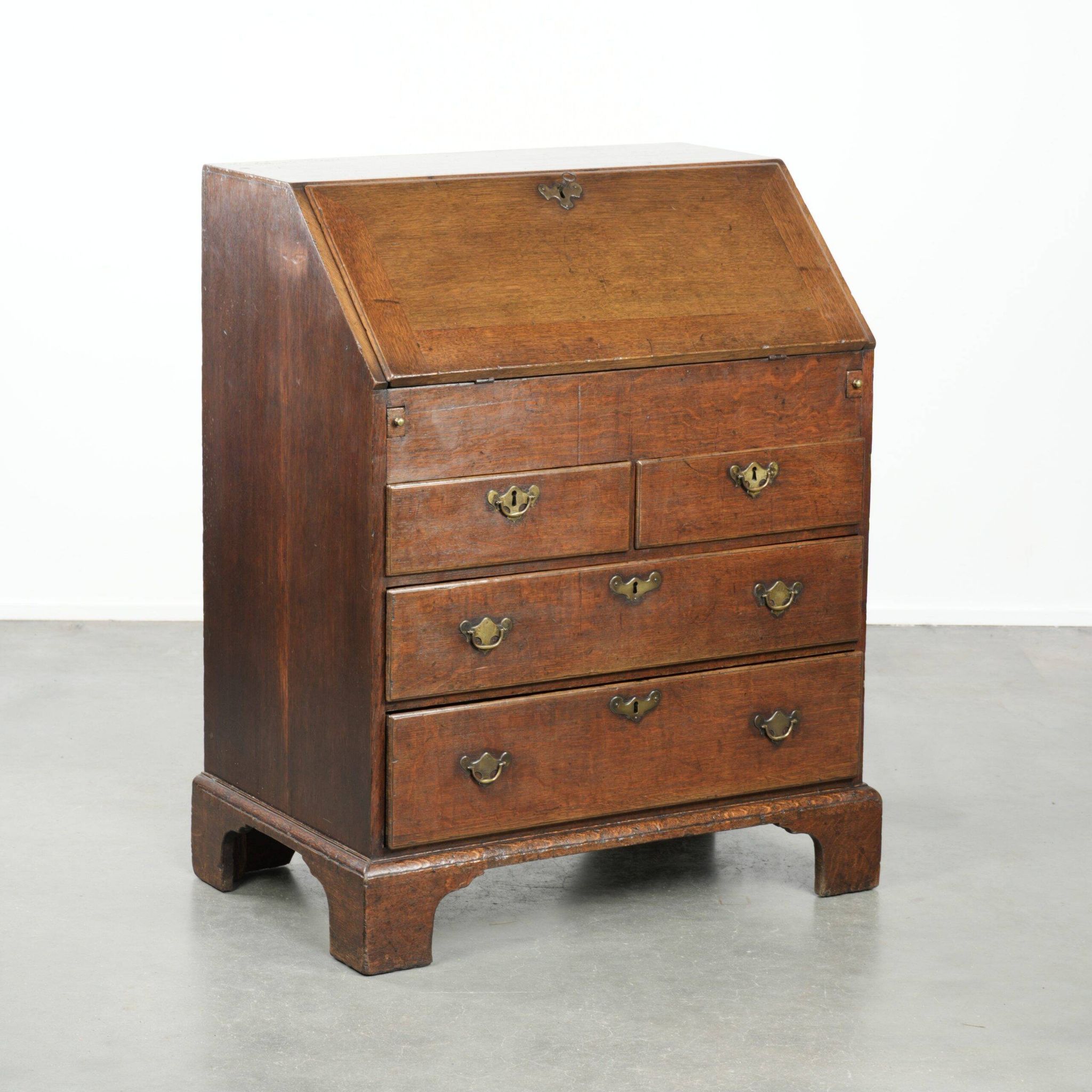 Antique English oak secretary from the 18th century with a stepped interior